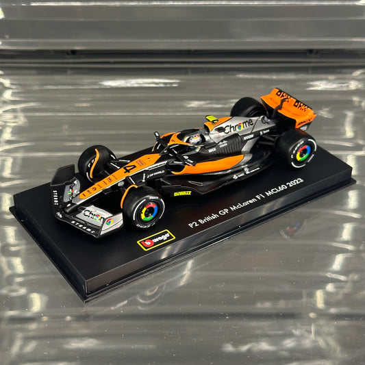 Bburago McLaren F1 MCL60 British GP Special Livery (2023) with Driver's Helmet & Showcase 1:43