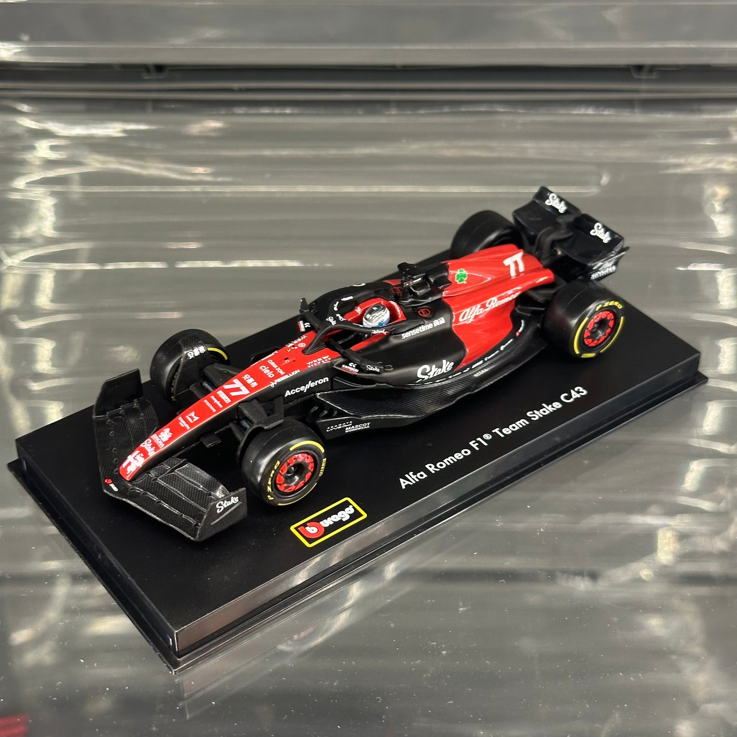 Bburago Alfa Romeo Stake F1 C43 (2023) with Driver's Helmet & Showcase 1:43