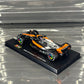 Bburago McLaren F1 MCL60 British GP Special Livery (2023) with Driver's Helmet & Showcase 1:43